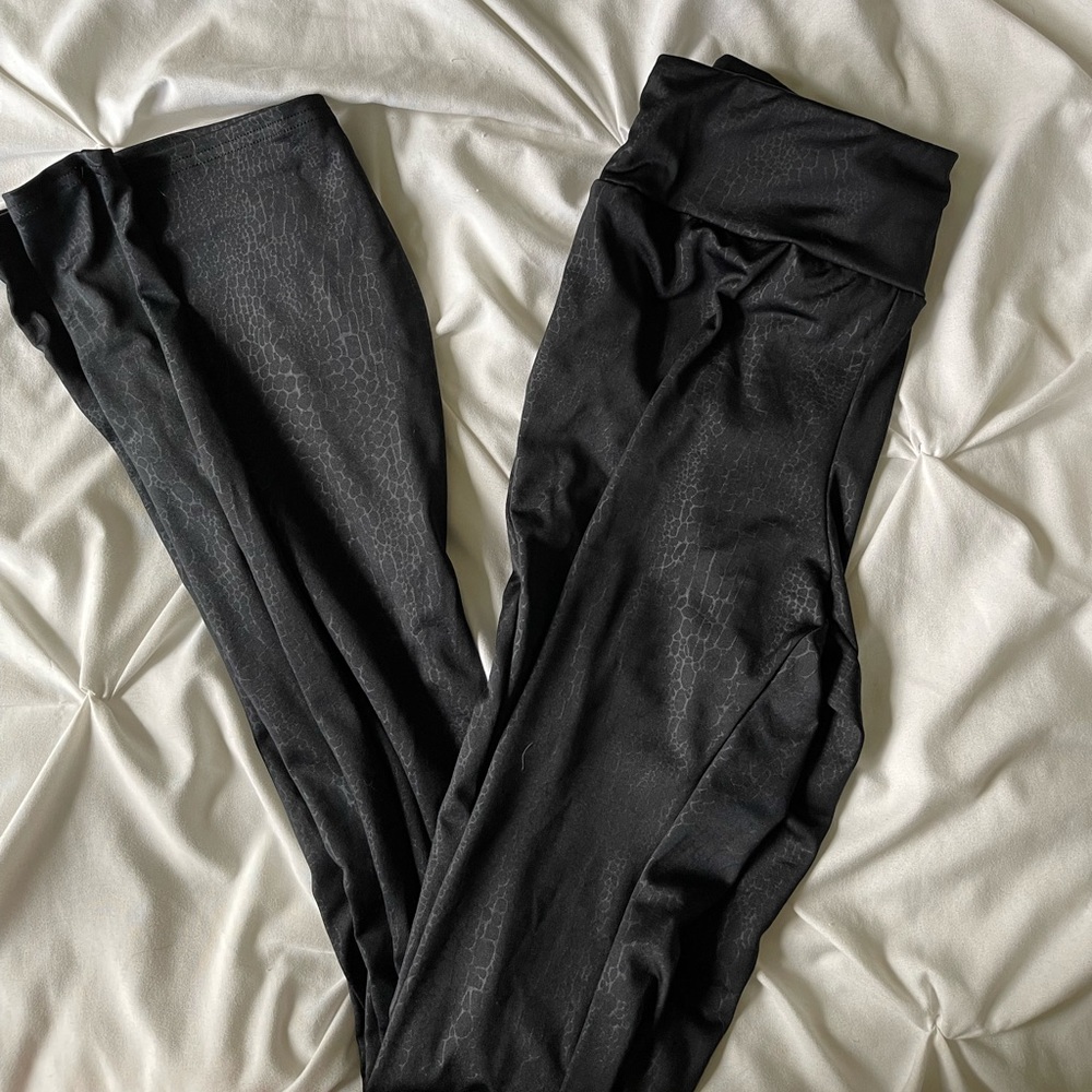 Black snakeskin print flare pants